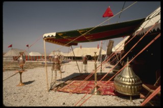 Oriental carpets and brass braziers at entrance of tent
