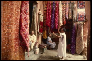 Bargaining for Oriental carpets at the Marrakesh bazaar